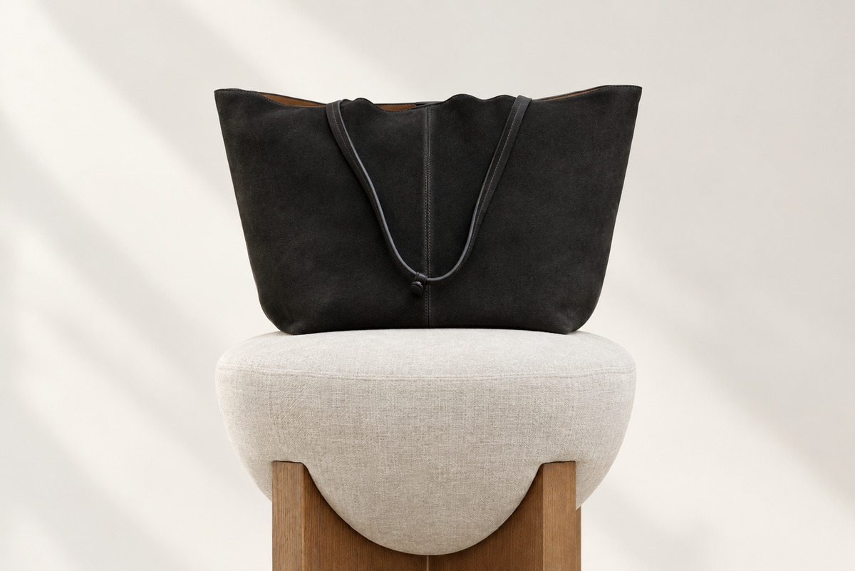 Black SWAYE tote on a cream stool
