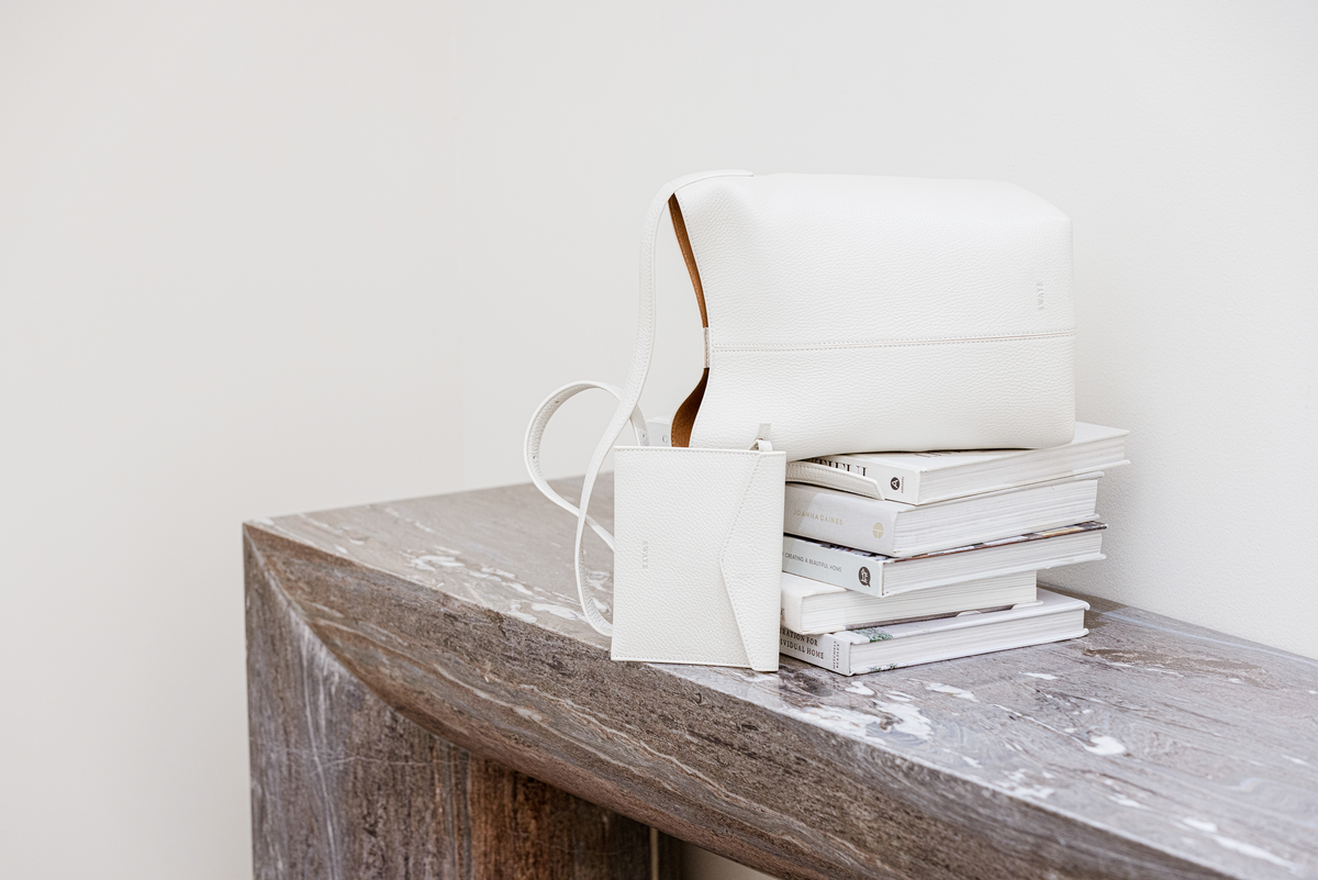 SWAYE leather handbag on a wooden console